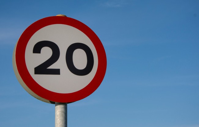 20 miles per hours road sign against a blue sky